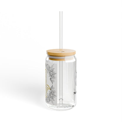 Clear glass tumbler with wooden lid and straw on a white background