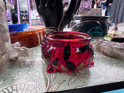 Open translucent crimson mini cauldron with black botanical detailing and gold accents
